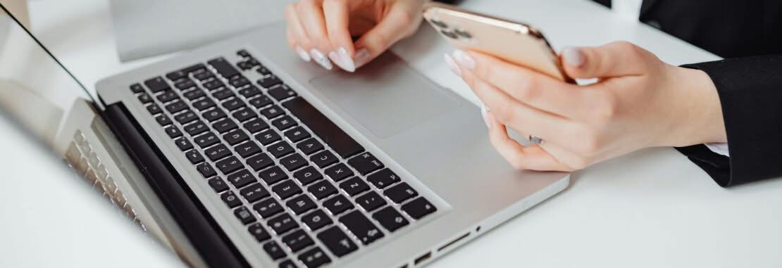 Customer booking Brilliance Crew cleaning service online in San Francisco using laptop and phone